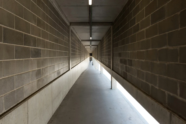 a hallway lined with a line of concrete walls