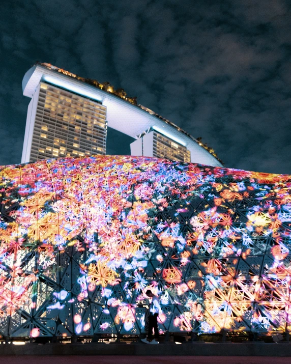 a very large building with a lot of colorful lights on it's side