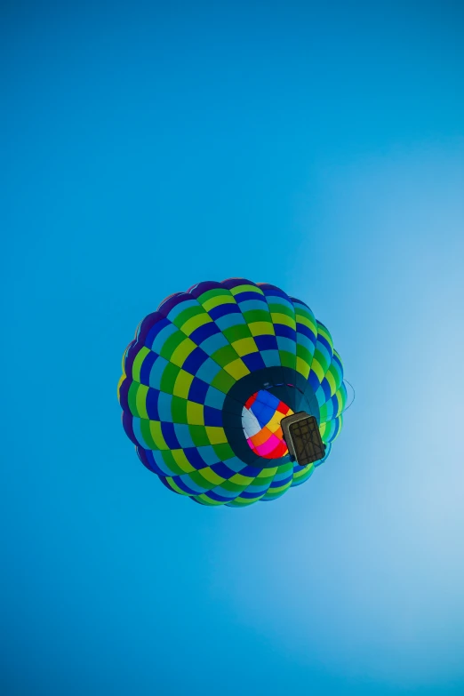 the colorful balloon is floating high in the air