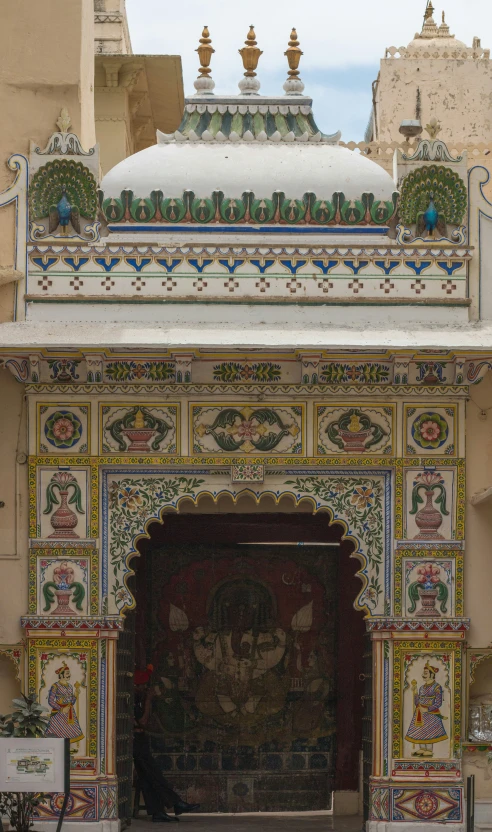 a decorated entry way with colorful painted panels and arches