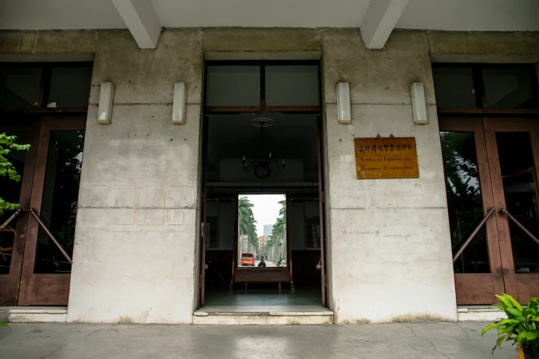 the front entrance of a building with tall doors and a clock