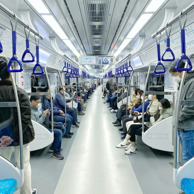 commuters sitting in seats on train or subway