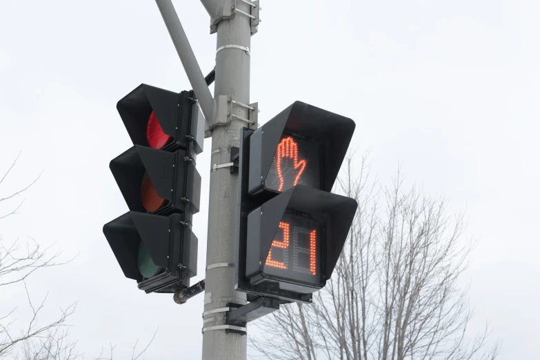 a traffic signal with a walk sign in the background