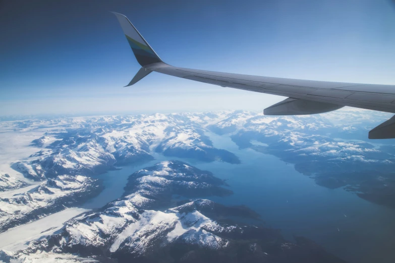 a view of a mountain range from the window of an airplane