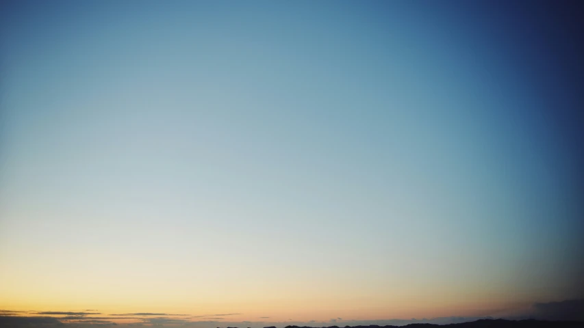 people are on the beach at sunset