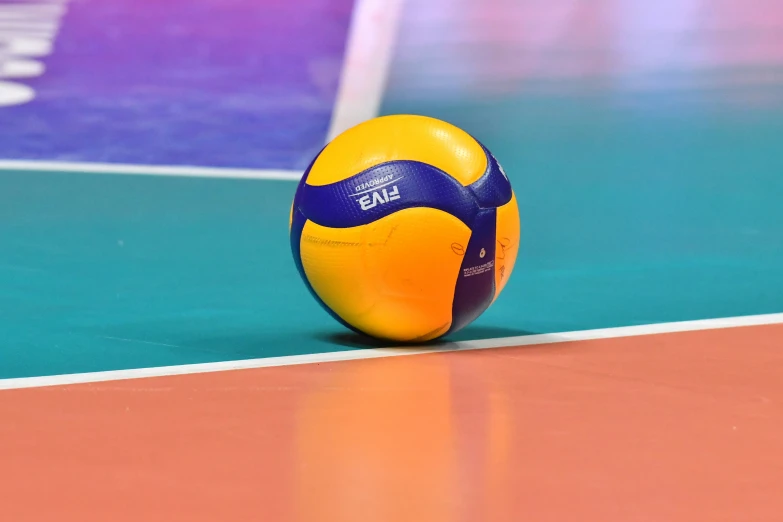 a volleyball sitting on top of a beach ball court