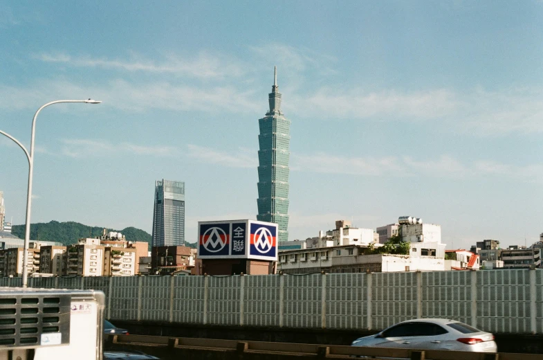 a bridge with traffic in a large city with tall buildings