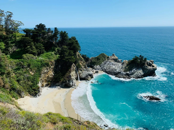 the beach is shown with waves crashing against the sand