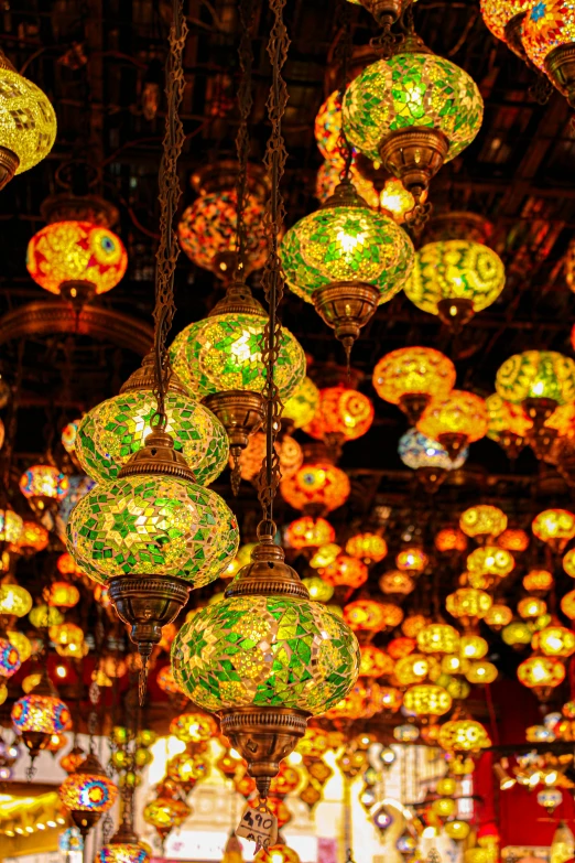 colorful glass balls are hung from chains inside a store