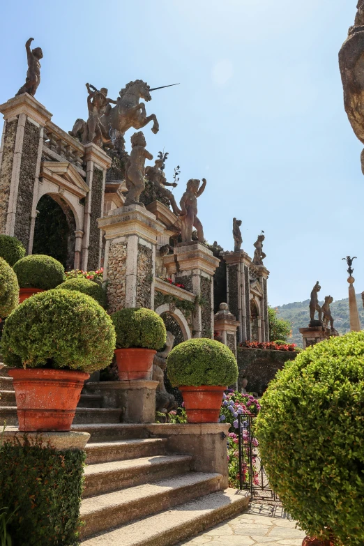 a building with stone stairs and statues around it