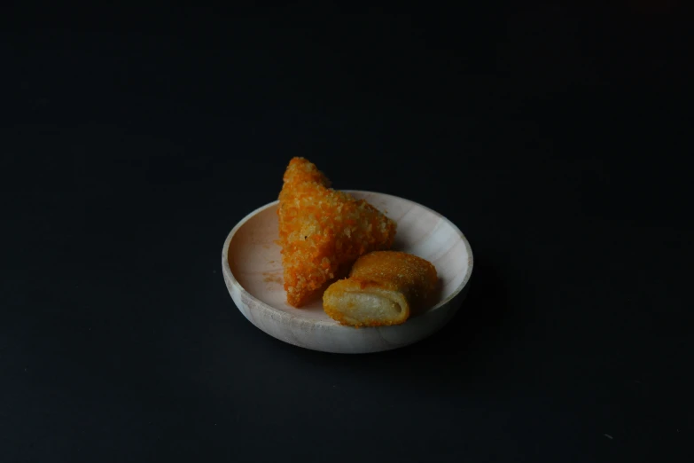 small bowls filled with food on a dark surface