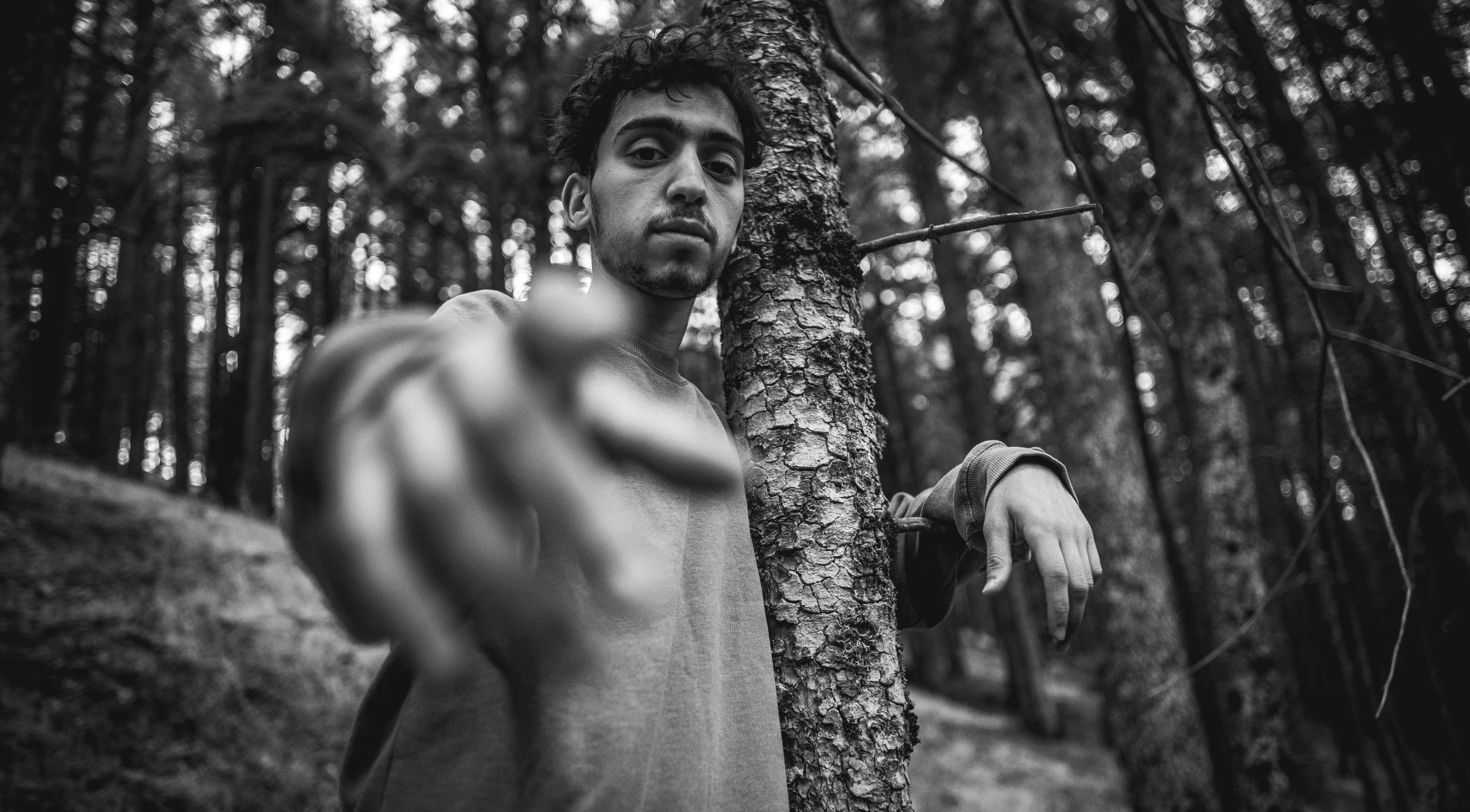 a  man standing near a tree