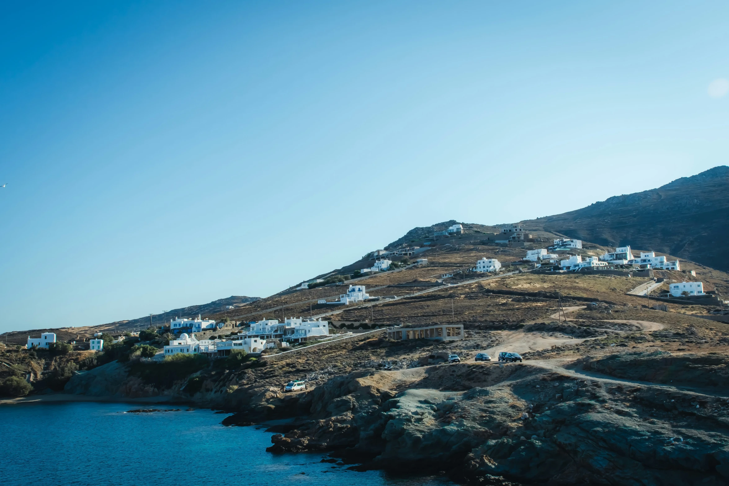 a hillside with houses perched on top of it