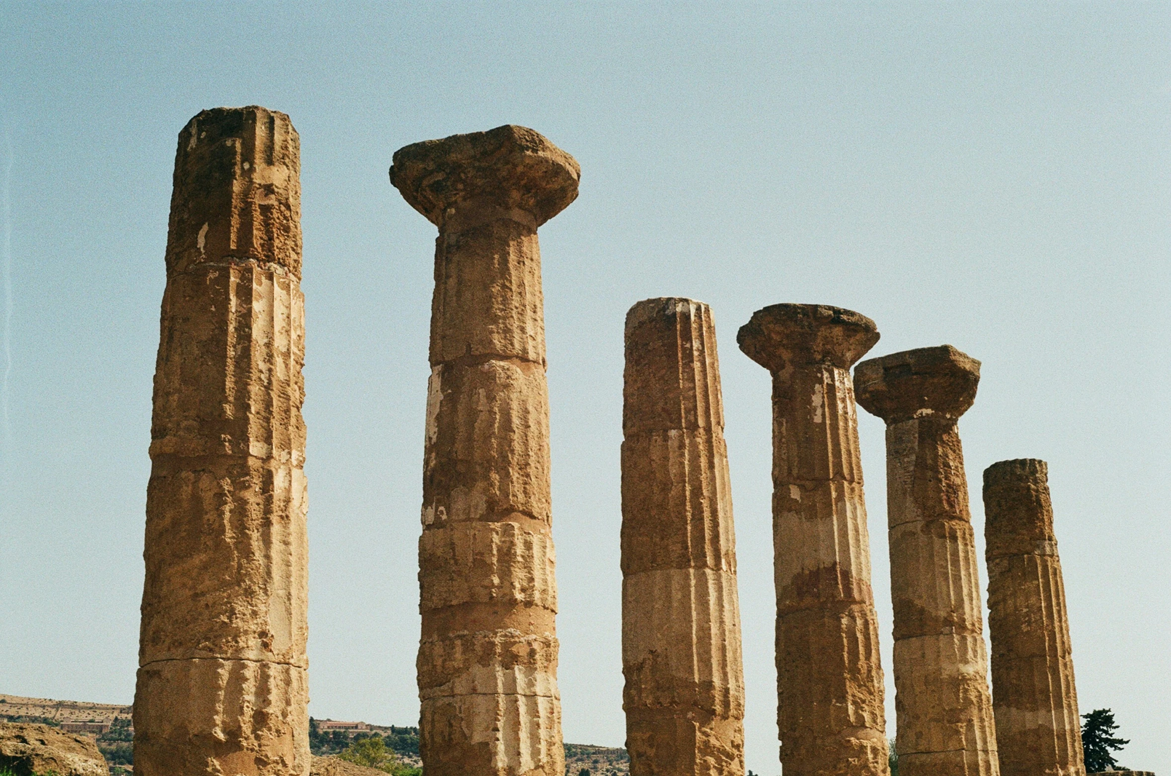 some very big tall pillars on a hill