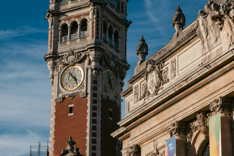 two clocks on top of a brick building