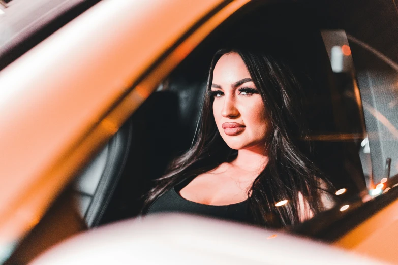 a girl sitting in a taxi waiting for her taxi