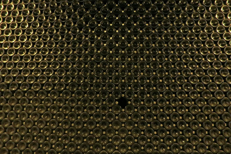 a view of a wall through holes in the surface