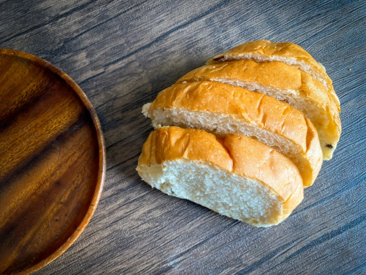 a loaf of bread next to a bowl on a table