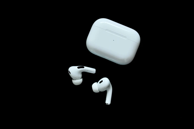 an airpods with an external case sits in the dark