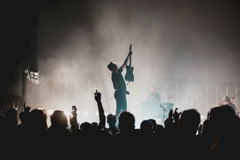 a group of people in front of a concert stage