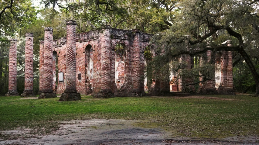 a large brick building with a lot of trees on both sides