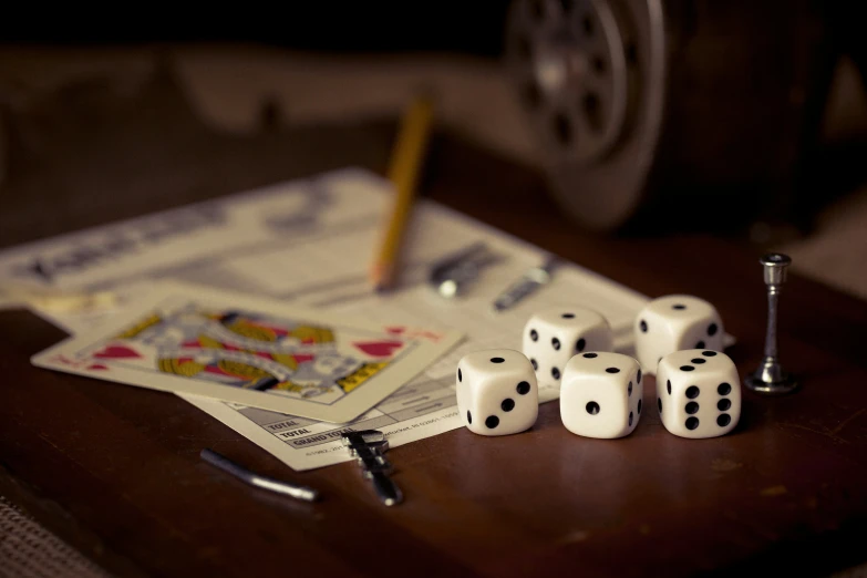 a few dice and a few nails on a wooden table