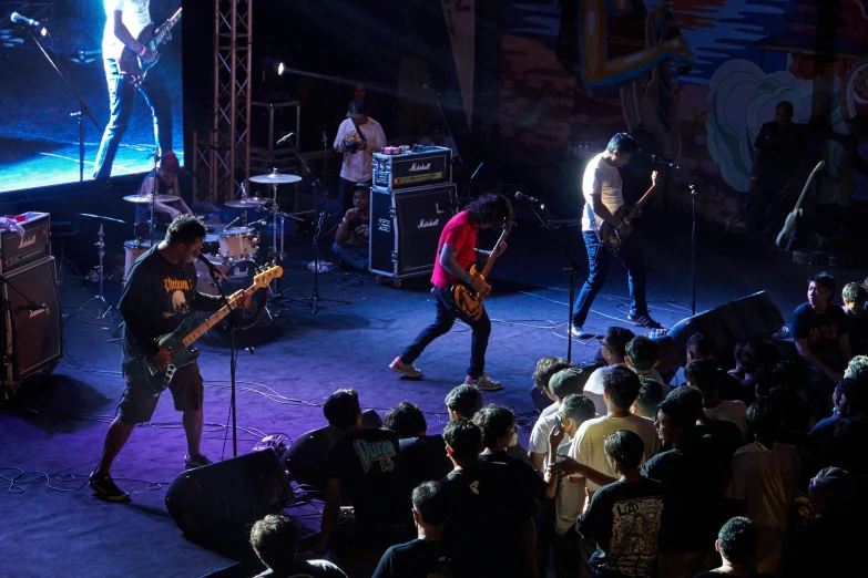 the band perform in front of a large group of people