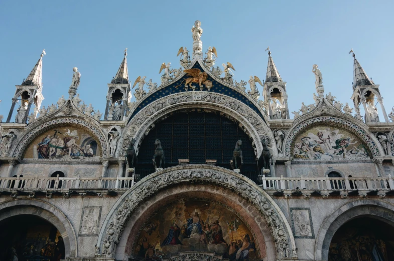 an ornate facade on a building with multiple murals