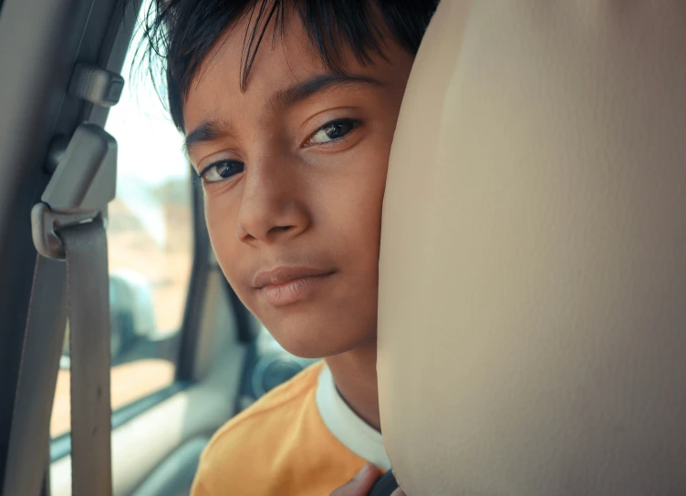 a  is sitting in a car and the front seats are empty