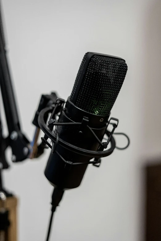 an old microphone with green light reflected in the background