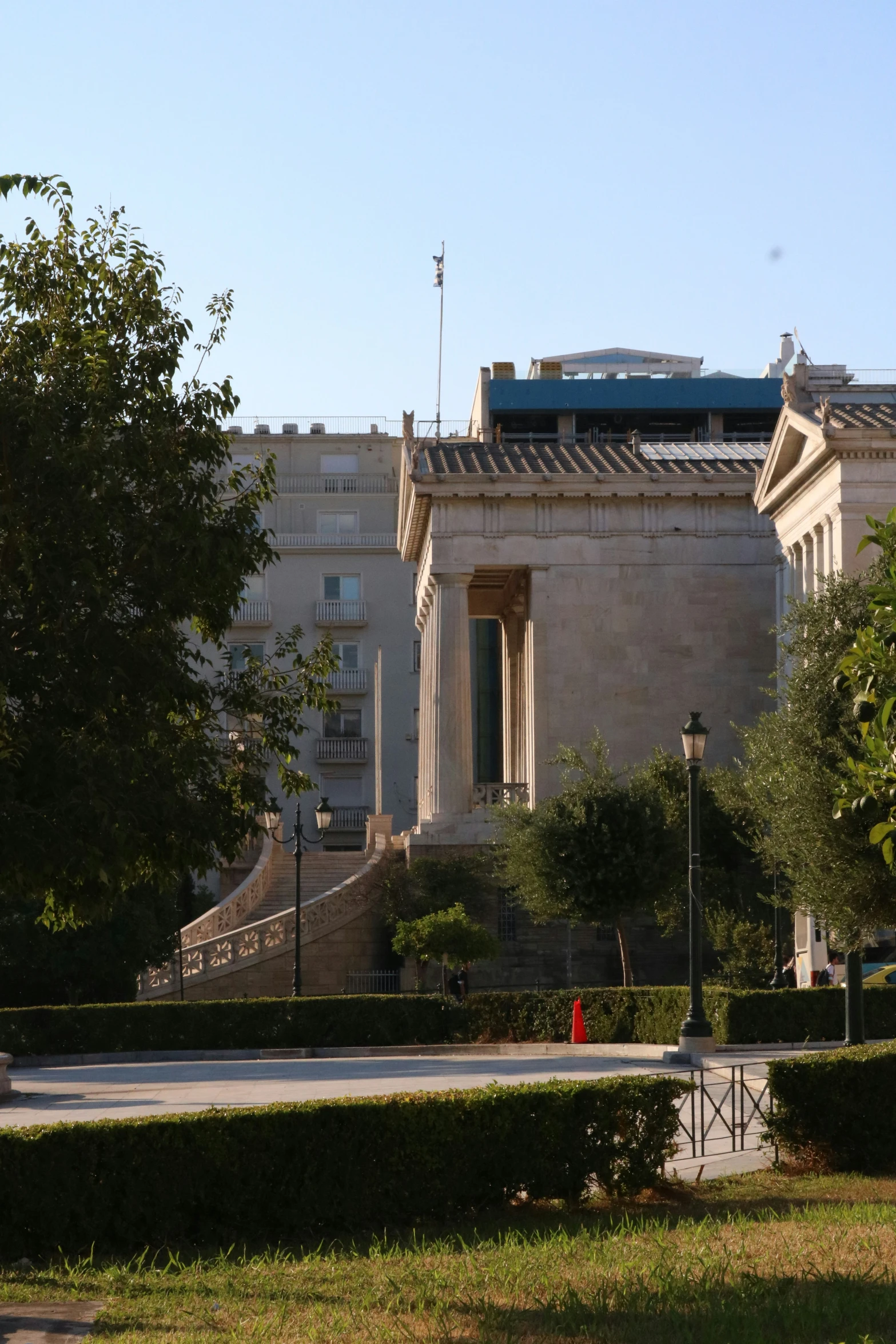 a large building in a city with a flag