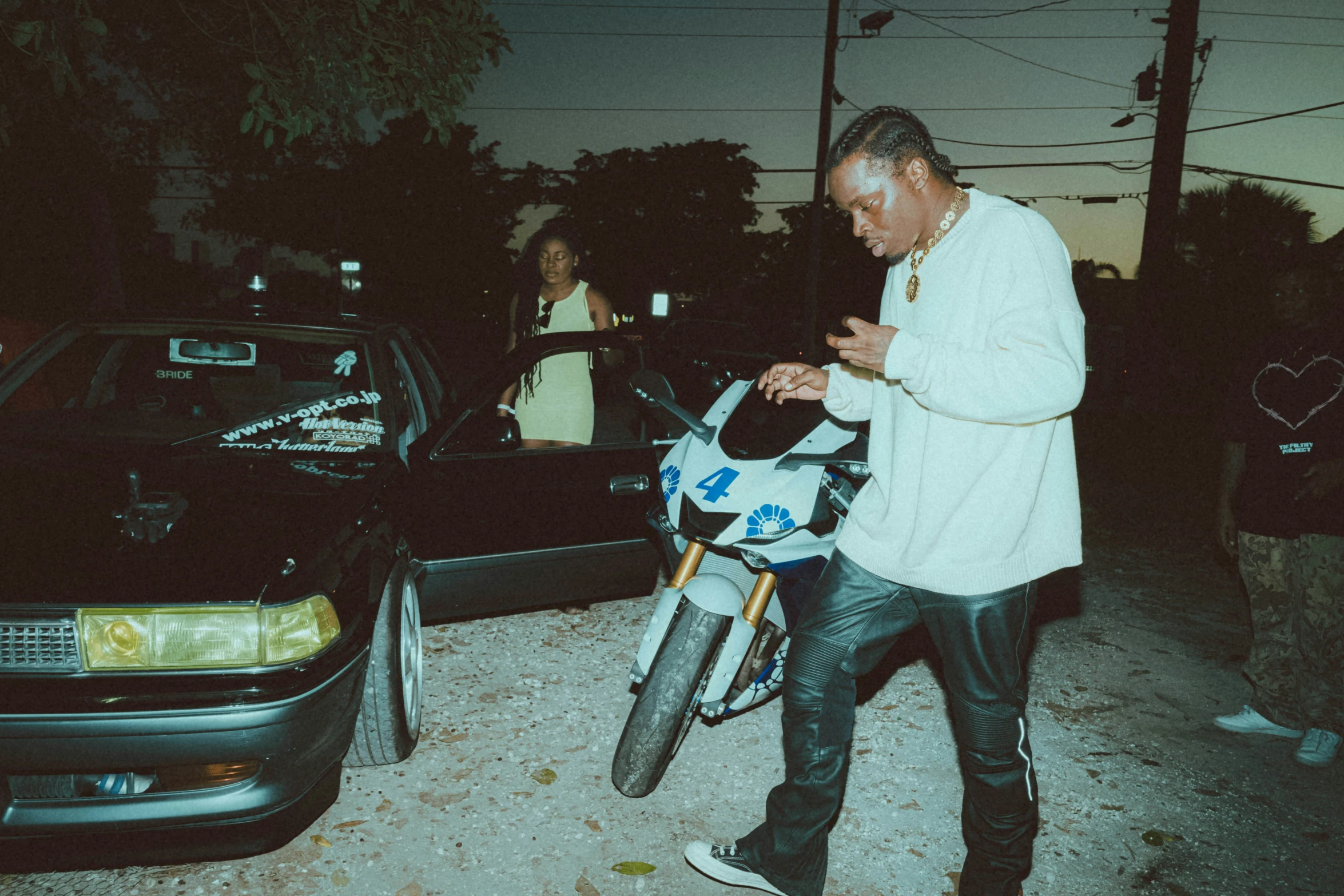 an image of man with a motorcycle in the street