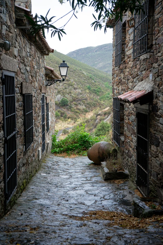 alley way with stone buildings and an open door