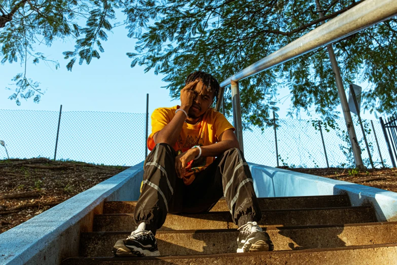 a person sitting down and holding a cell phone