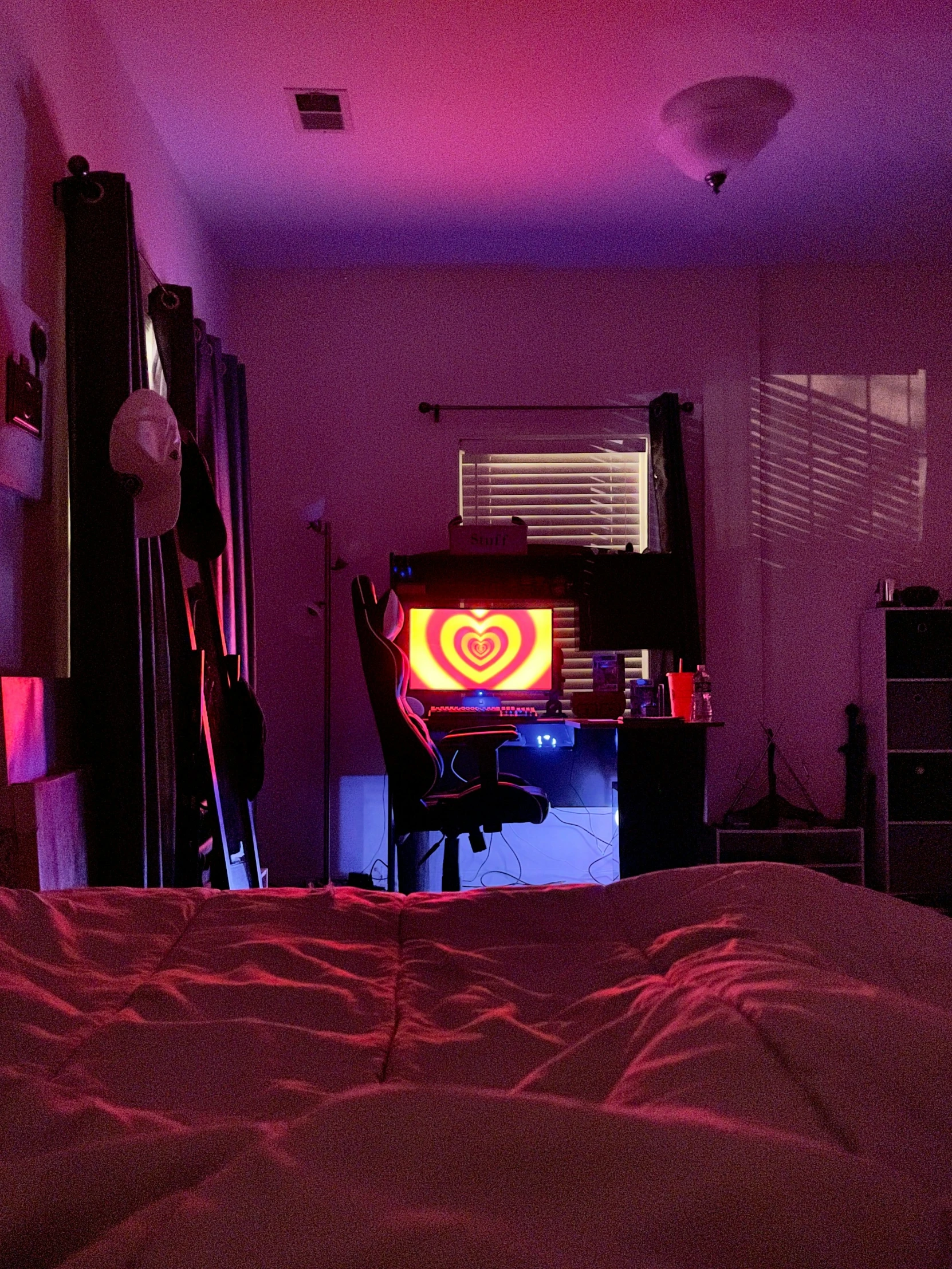 a room that has purple lights and a bed in it