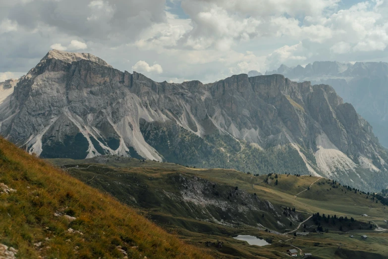 the view of a grassy, rocky area in front of a mountain range