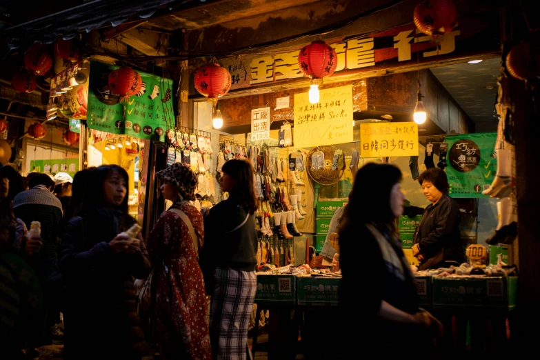 people standing around a shop that sells goods