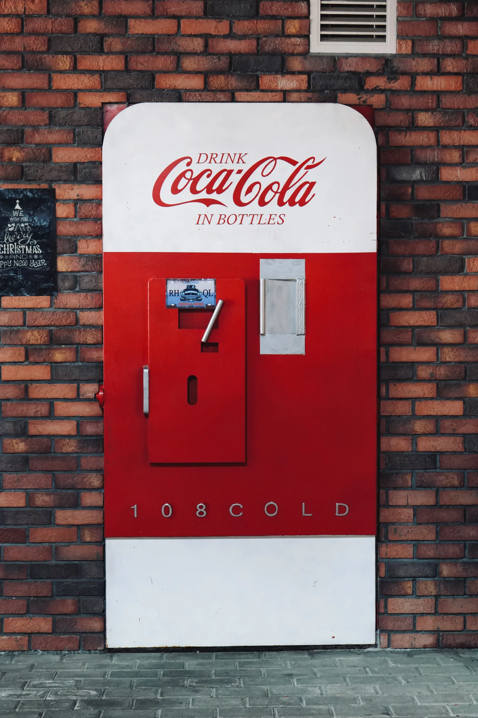 a close up of a coca cola machine near a wall
