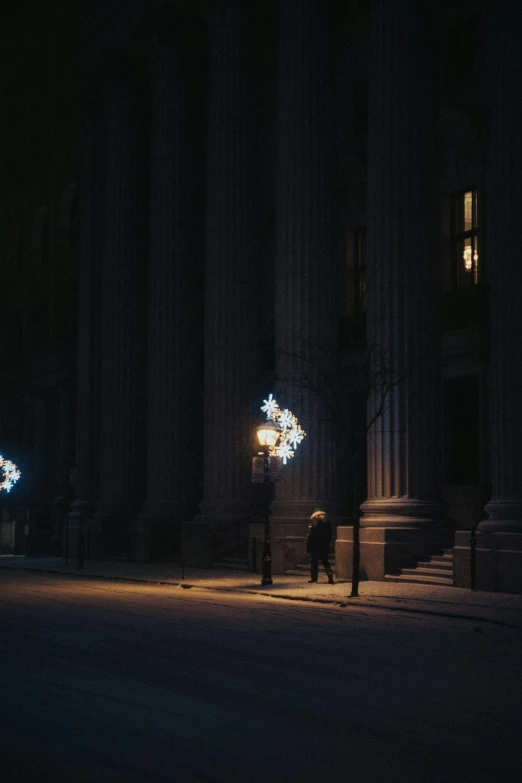 a man walking through the dark night street