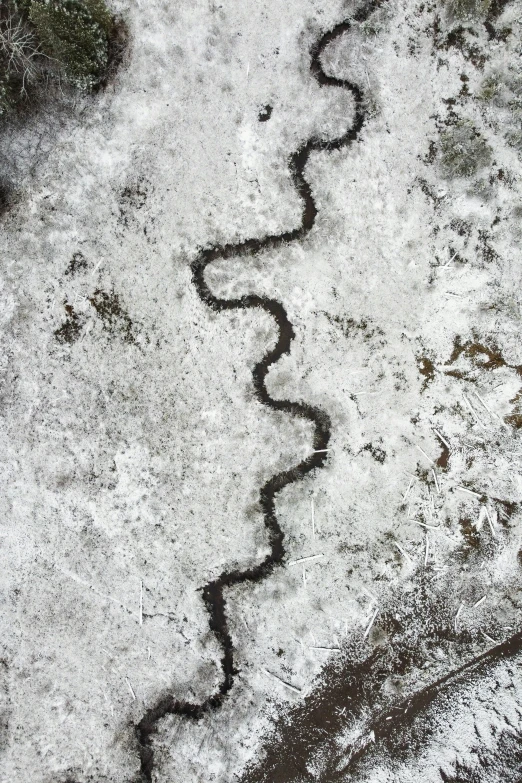 traces in the snow are drawn on to the street