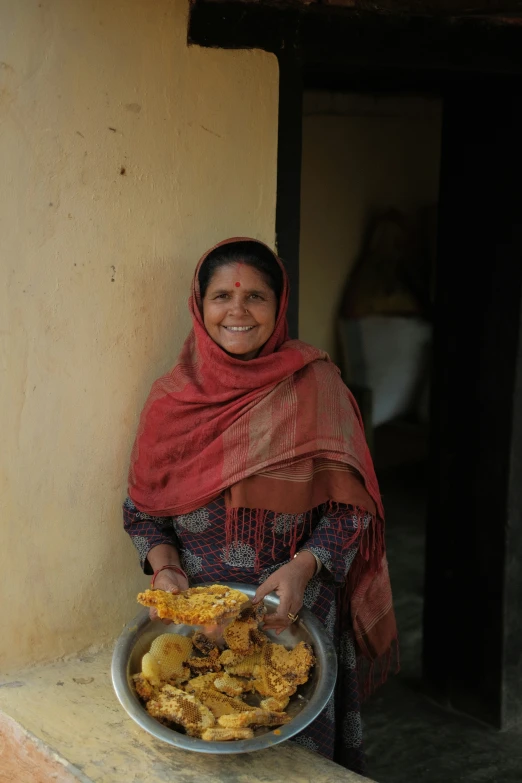 a woman smiling with food on her hands