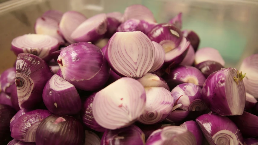 a pile of onions sitting inside of a container