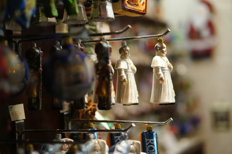 souvenir figurines hanging on a shelf in a store