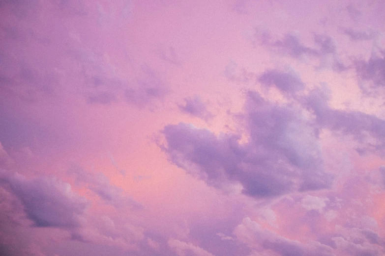 a cloudy sky is purple, pink and blue