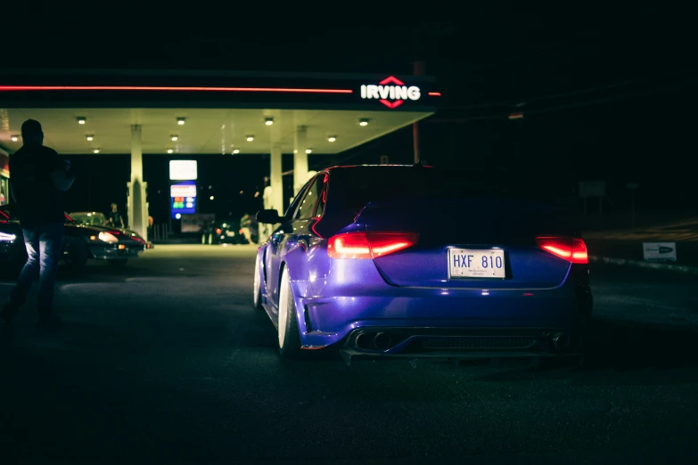 car parked in front of gas station with license plate