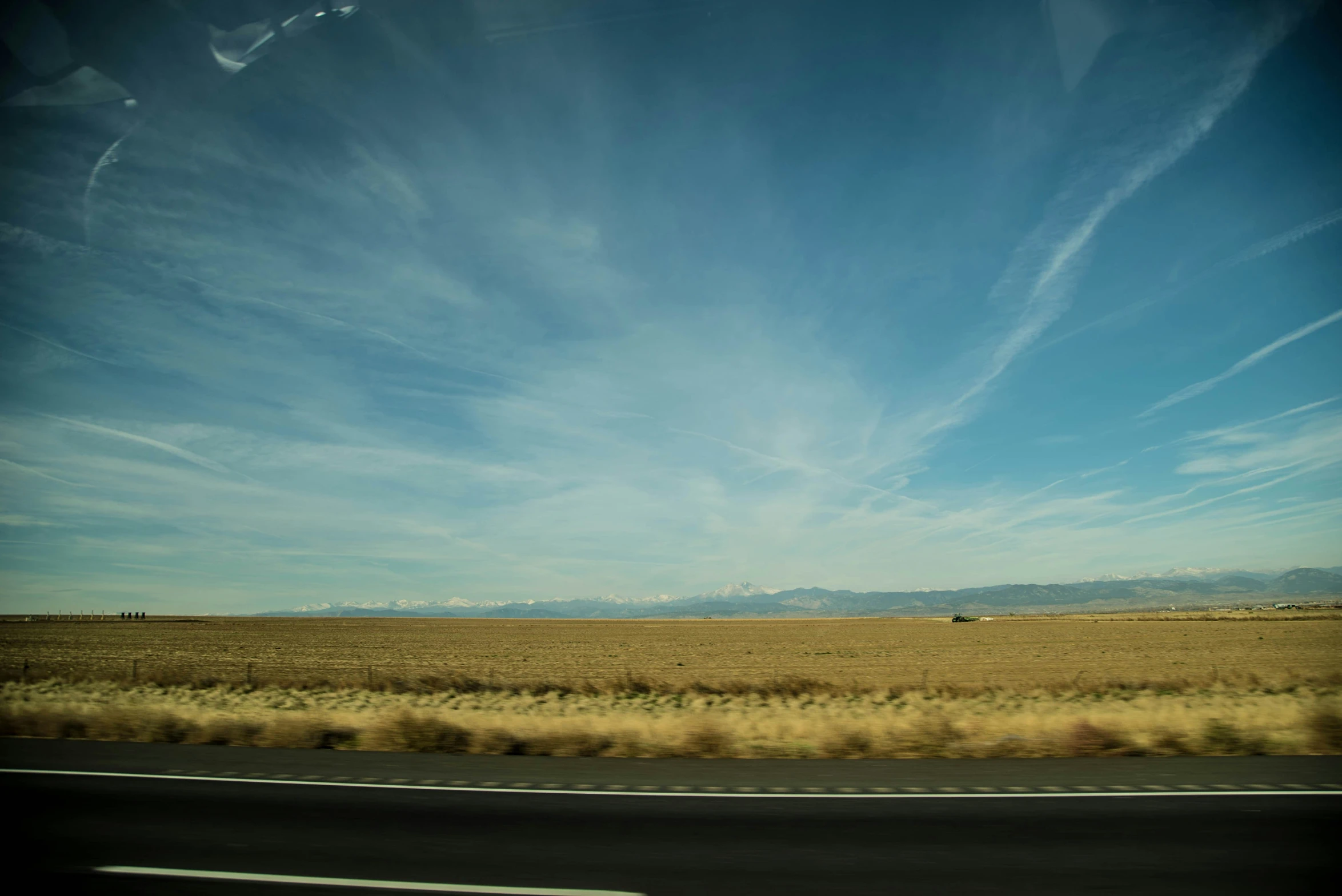 the sky is blue, fluffy, and some clouds are visible in the distance