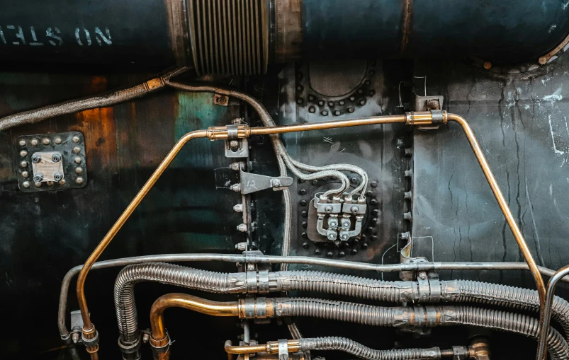 closeup of pipes and valves on the inside of a steam locomotive