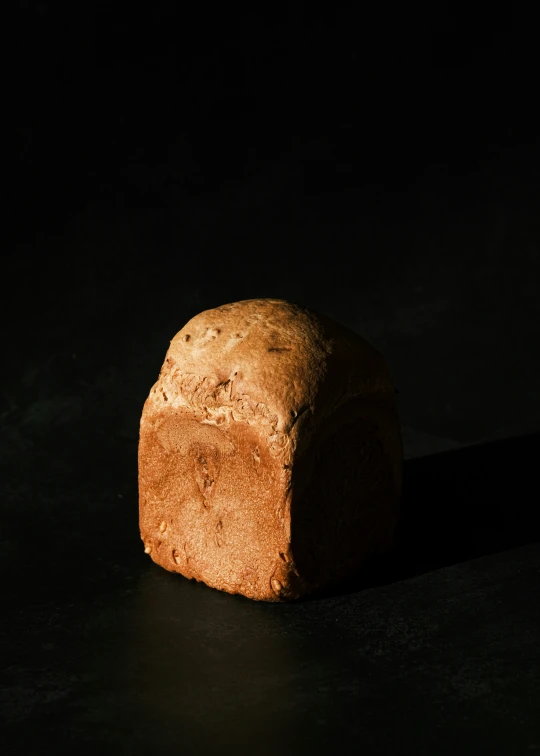 the bread is sitting on the table in the dark