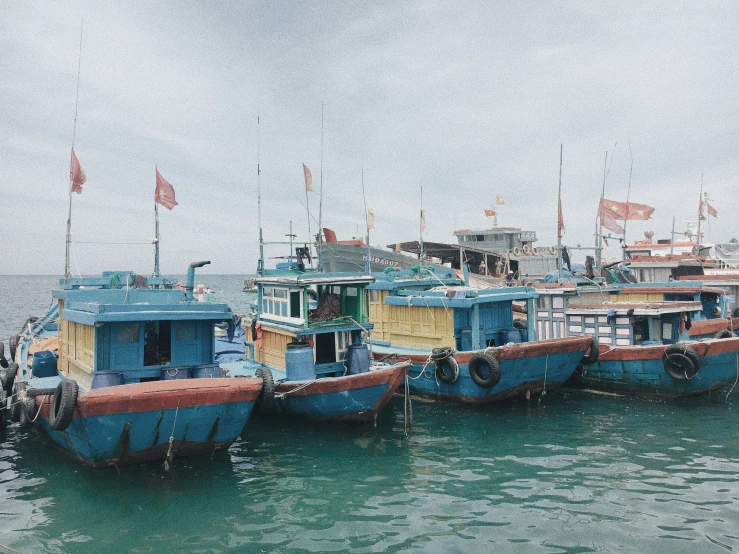 several small boats lined up together on the water