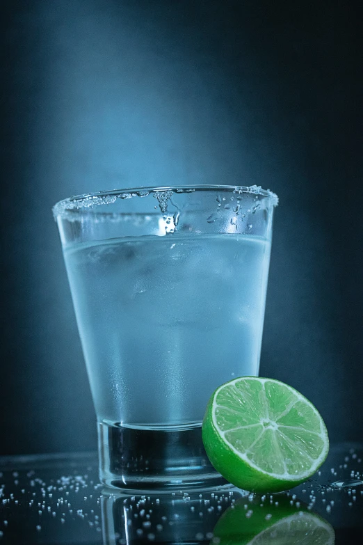 water, lime and lime slices are sitting on the surface